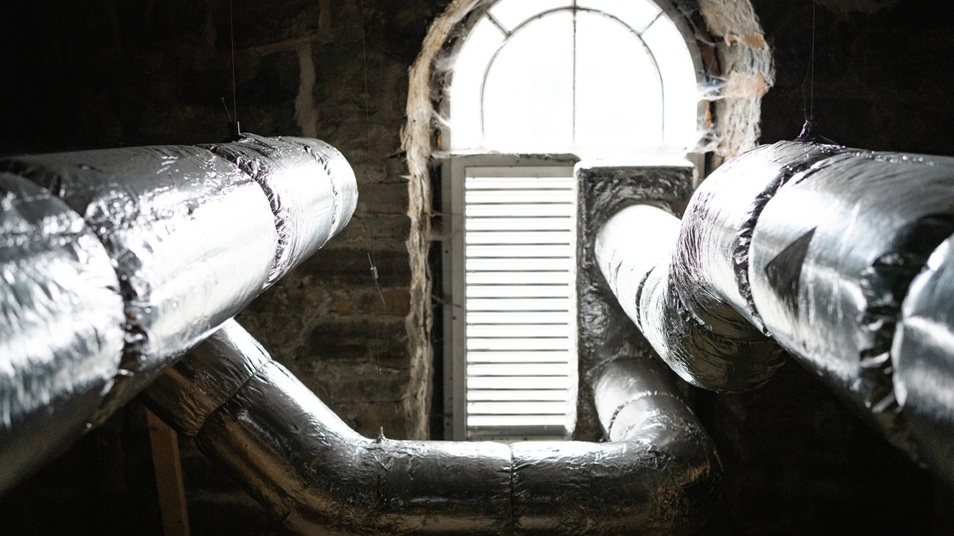 The inside of an old church with a newly fitted high-tech ventilation/heat recovery system