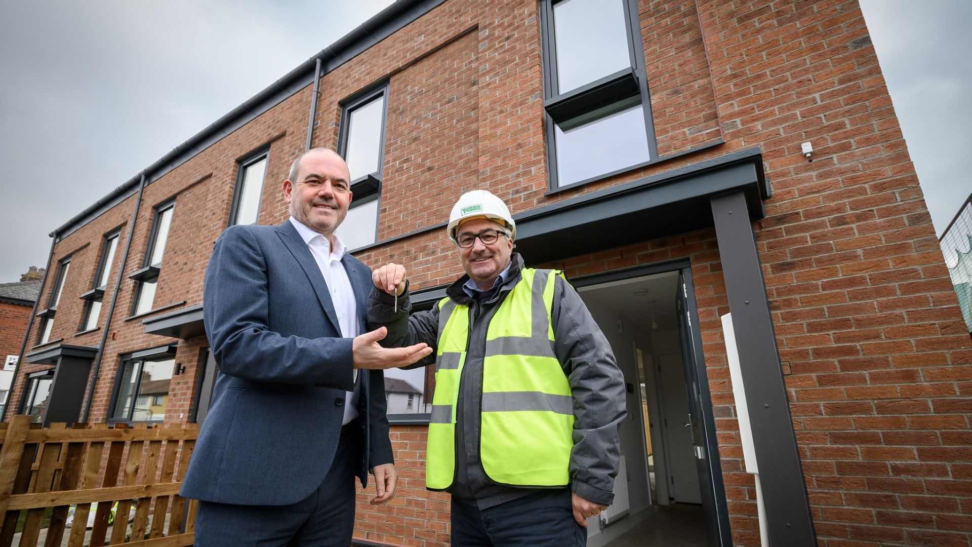 Councillor Paul Foster and Scott Eastwood in front of one of the new homes.