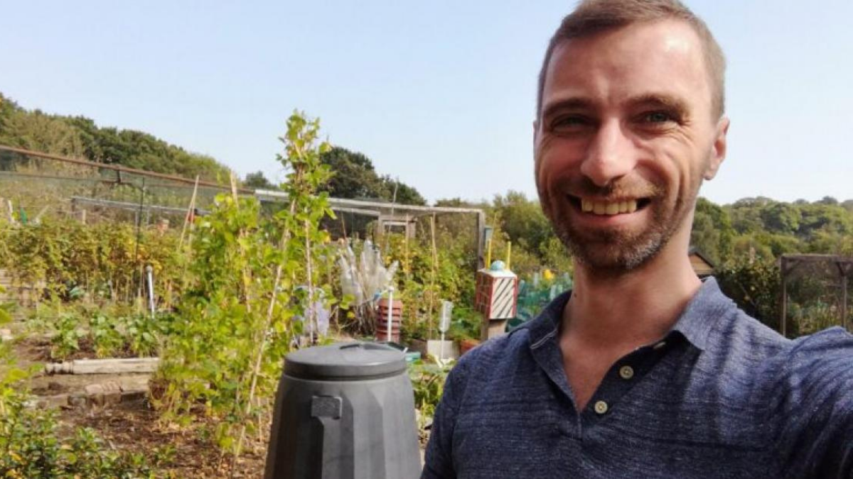 A selfie of councillor Adam Harrison at an allotment on a sunny day