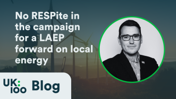 Image showing wind turbines in the background with text overlay reading 'No RESPite in the campaign for a LAEP forward on local energy' featuring a wordplay on RESP and LAEP initiatives. The UK100 Blog logo appears in the bottom left corner, and the right side displays a circular portrait of a man in professional attire wearing glasses, likely Christopher Hammond, Chief Executive of UK100. The image relates to local energy planning advocacy.