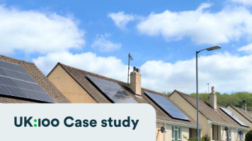3 detached bungalow new build houses with solar panels in a blue sky with white fluffy clouds