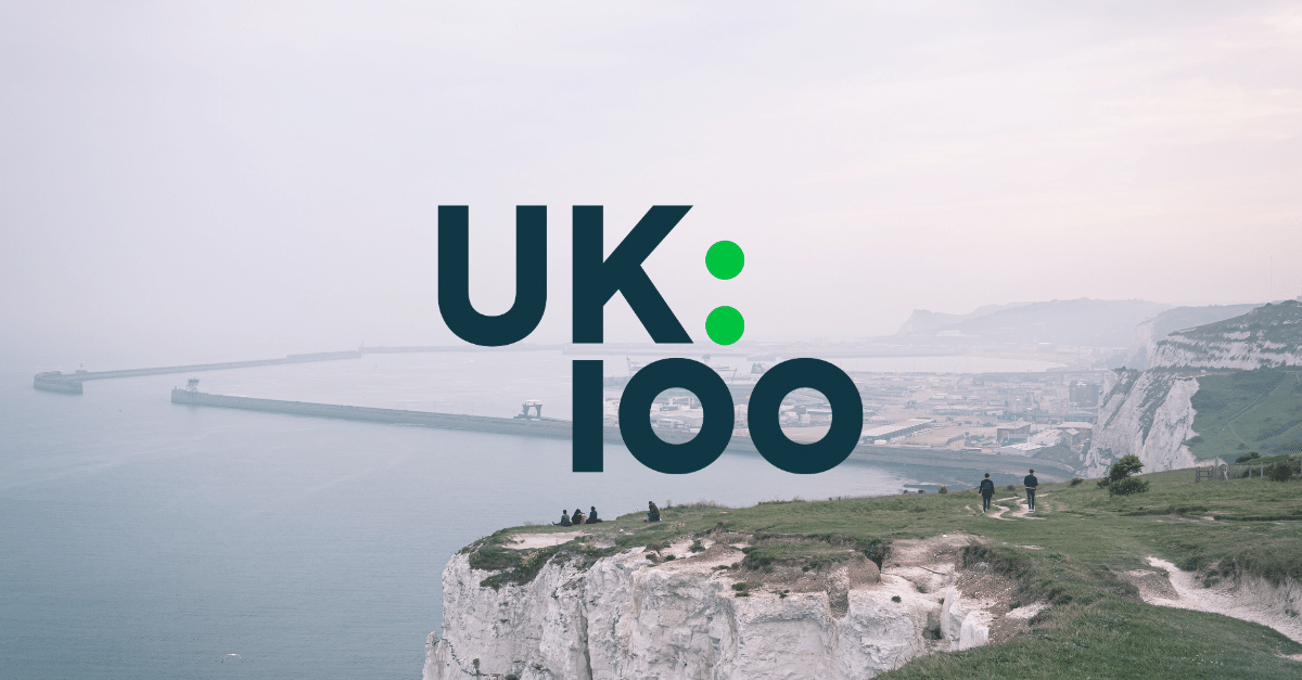 UK100 Logo with coastal background